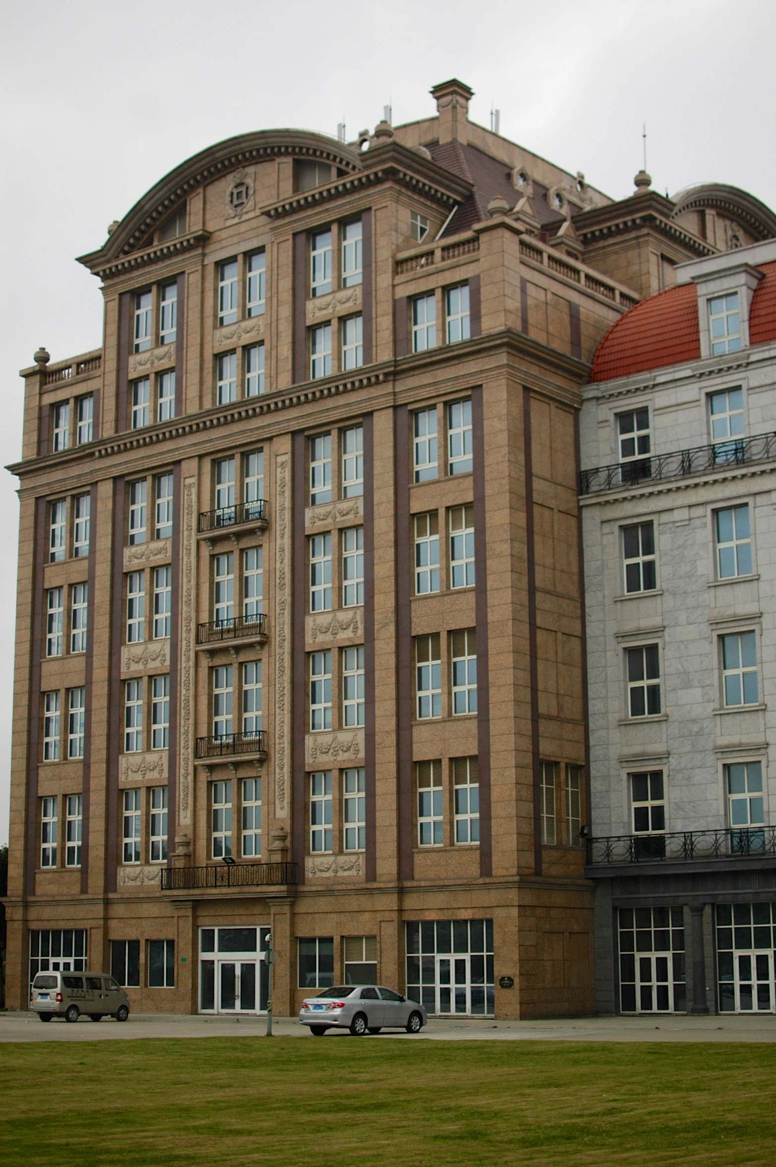 a big building with several cars parked in front