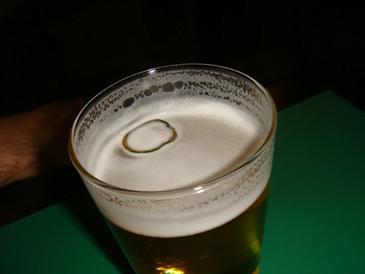 a glass of beer with some bubbles on it