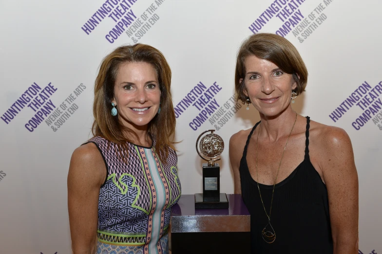 two women pose with the award they won in competition