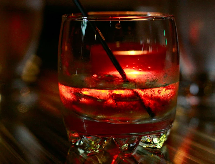 glass on a table with drinks in it