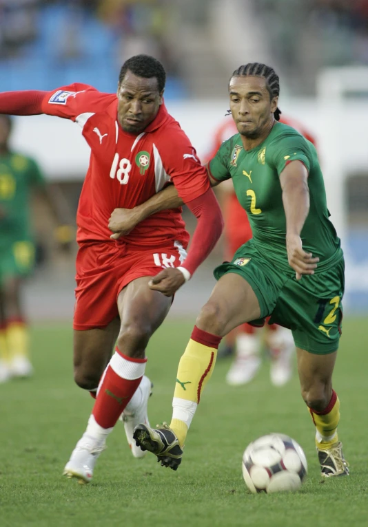 the two men are playing soccer in the field