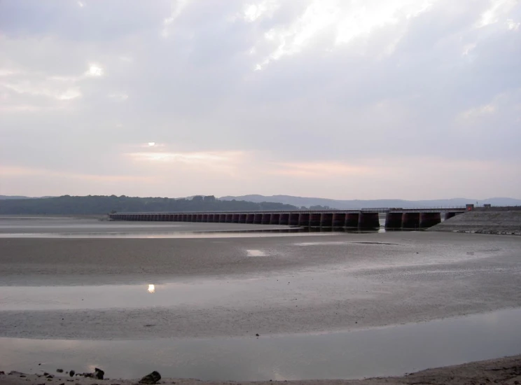 a bridge crosses the water at low tide