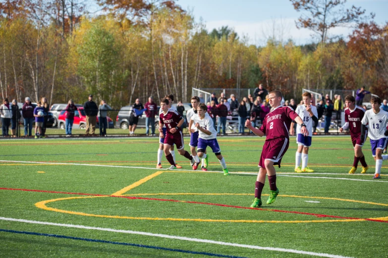 a group of men on a field playing soccer