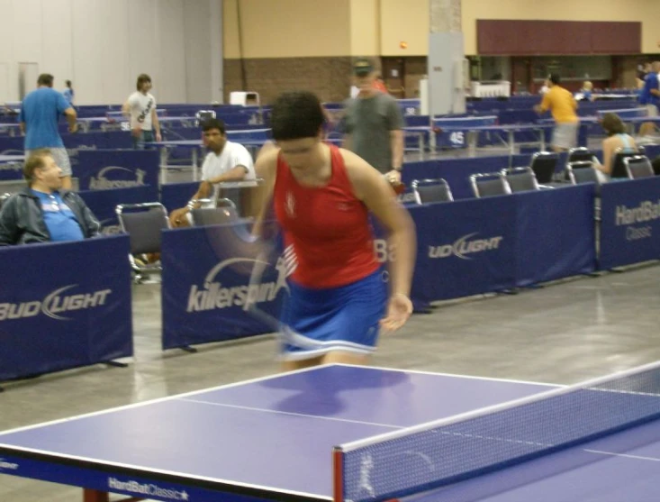 a man hitting a ball with his ping pong racket