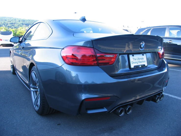 the rear end of a dark gray sports car