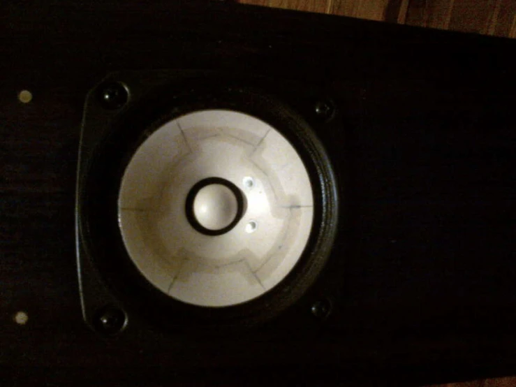 a speaker on display in a wood box