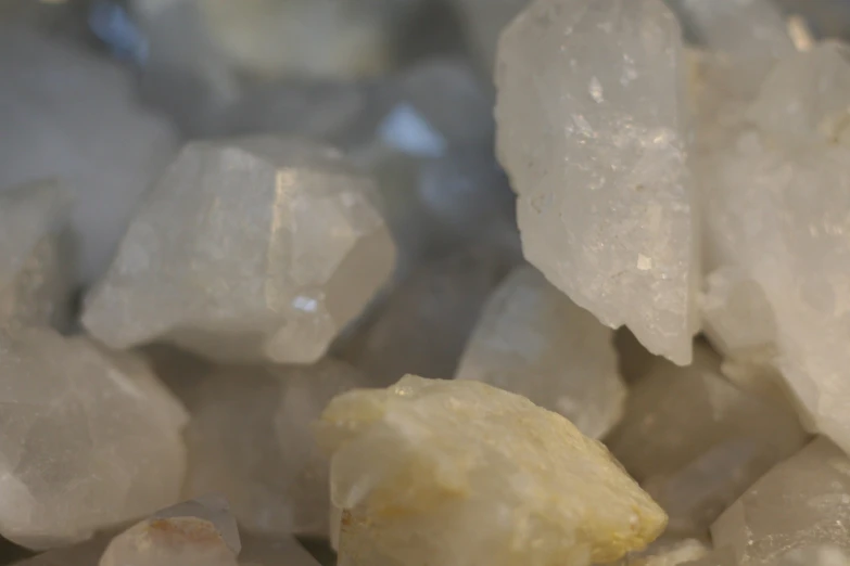 some clear crystals that have yellow colored, rock like substance in them