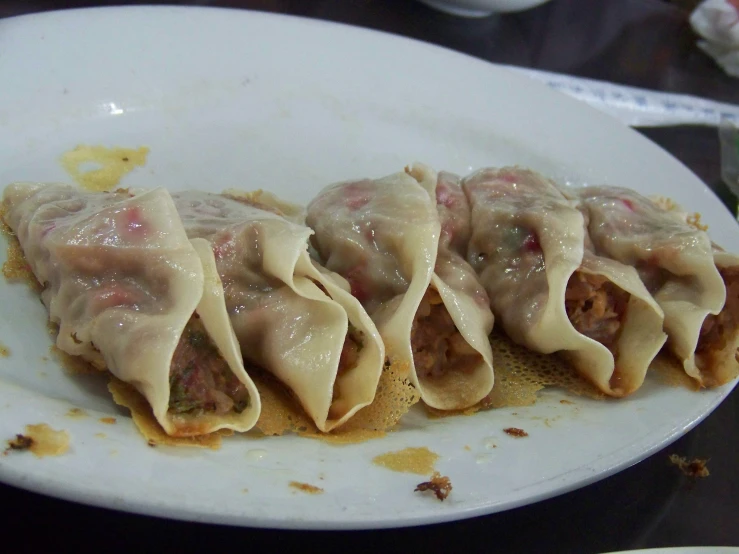 a plate with some food that has a bunch of sauce on it