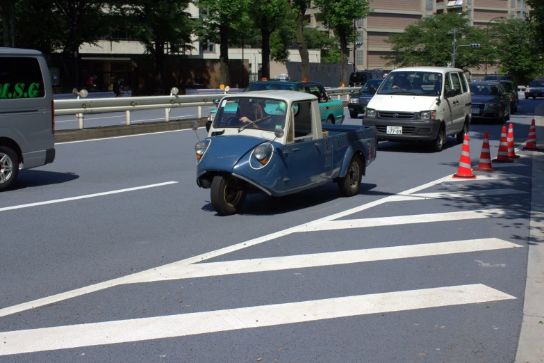 a mini car that is being driven through some traffic