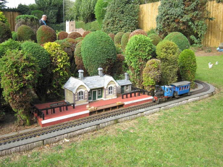 a toy train on a track in the garden