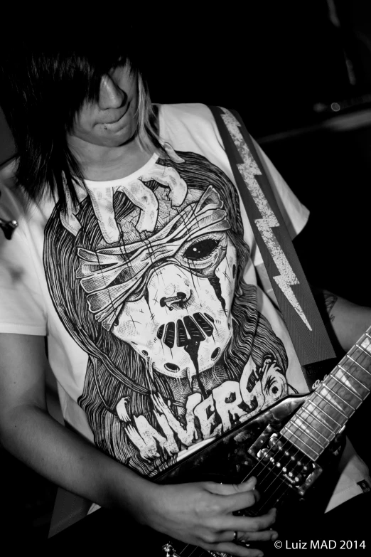 a girl is playing guitar with her hand