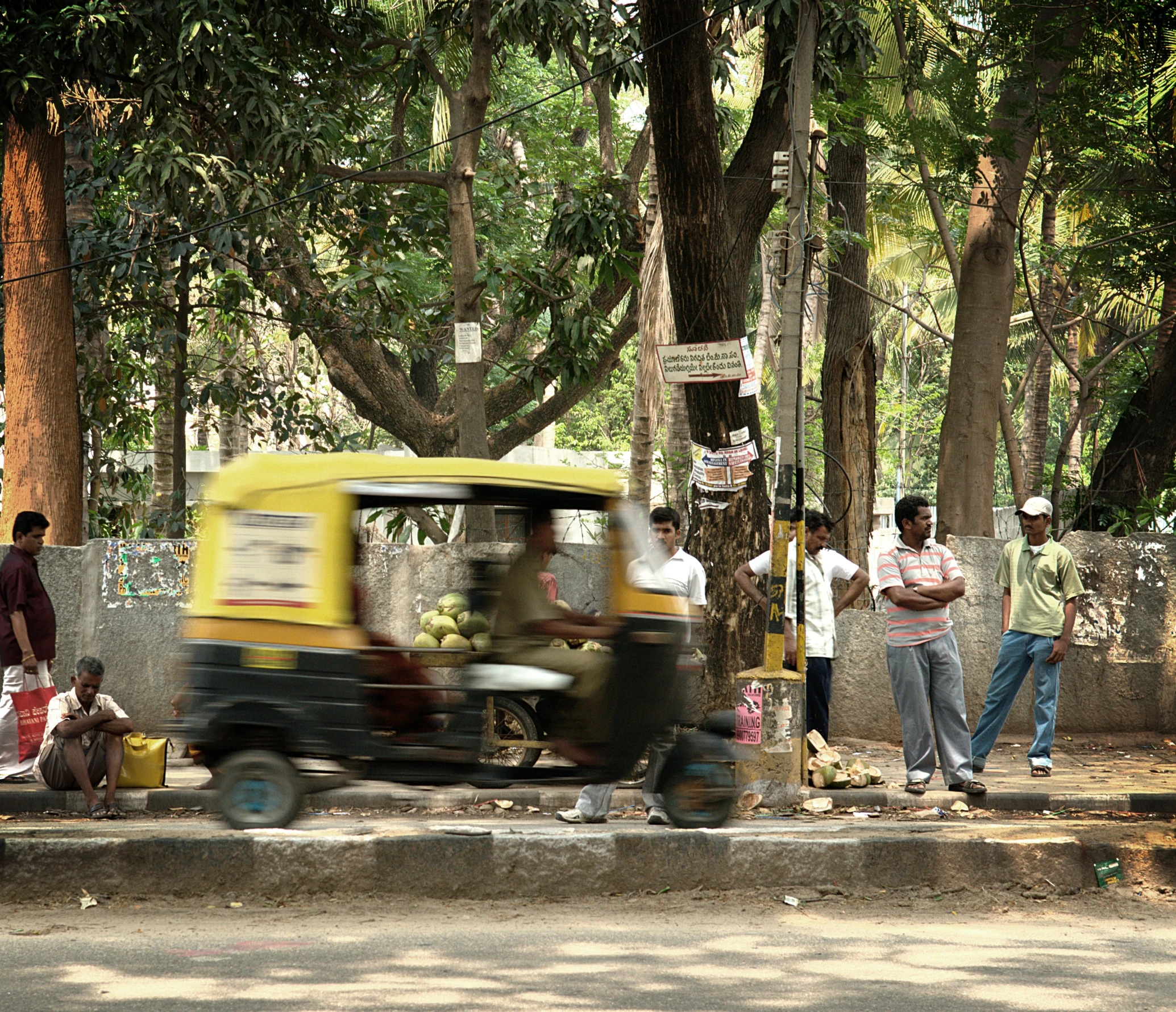 a person is riding an open car near people on the road