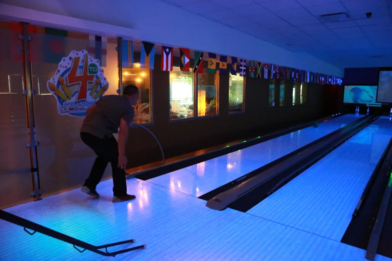 two people playing an arcade bowling game