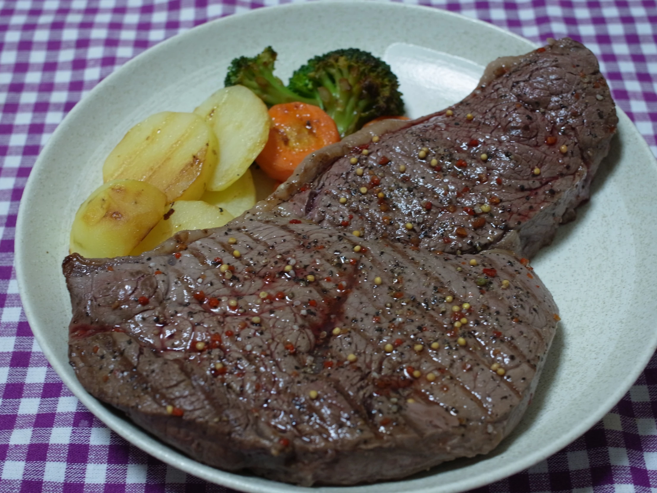 a plate full of meat, potatoes and broccoli