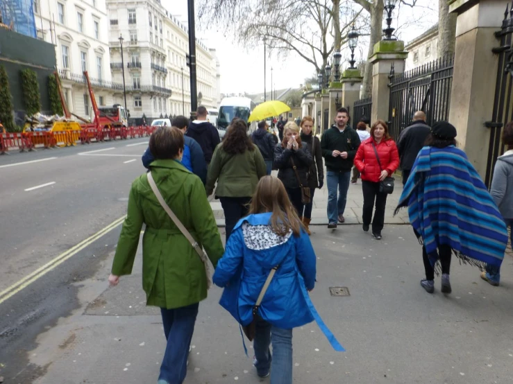 the children walk with their umbrellas up to school