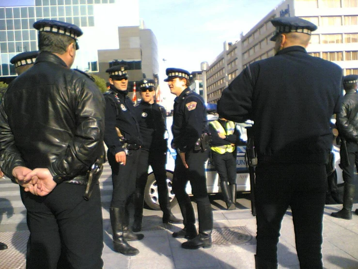 a group of police standing on the side of a road