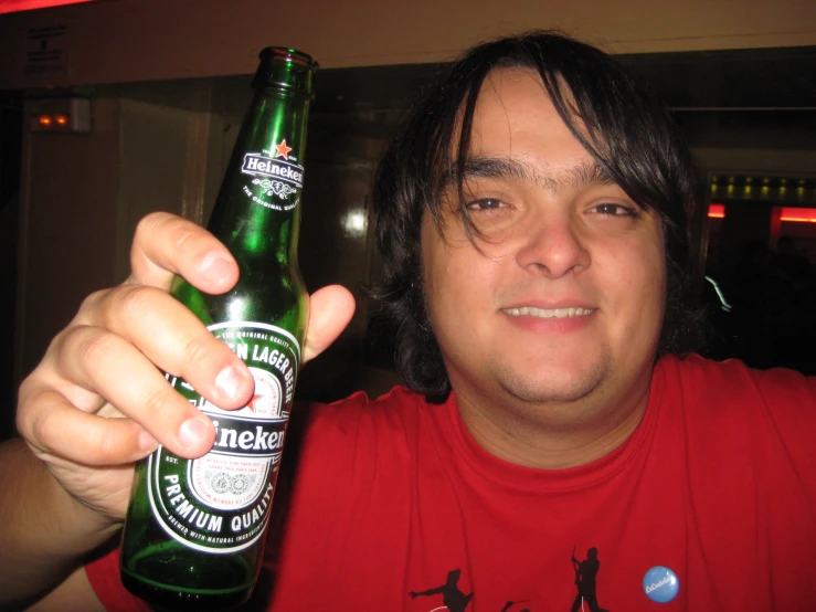 man holding beer in left hand in a diner