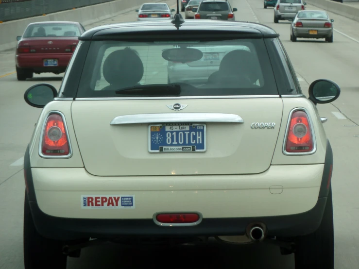 the back end of a white car with license plates