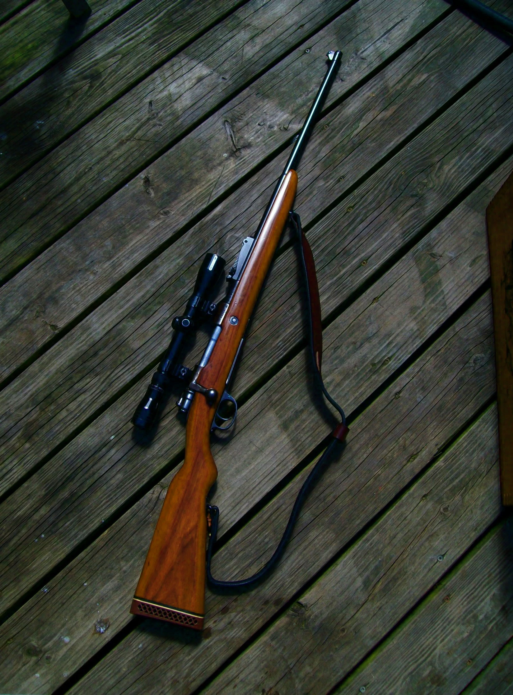 a close up of a rifle on a wood table