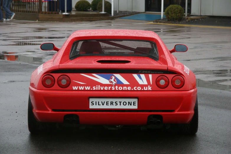 the red sports car is parked on the road