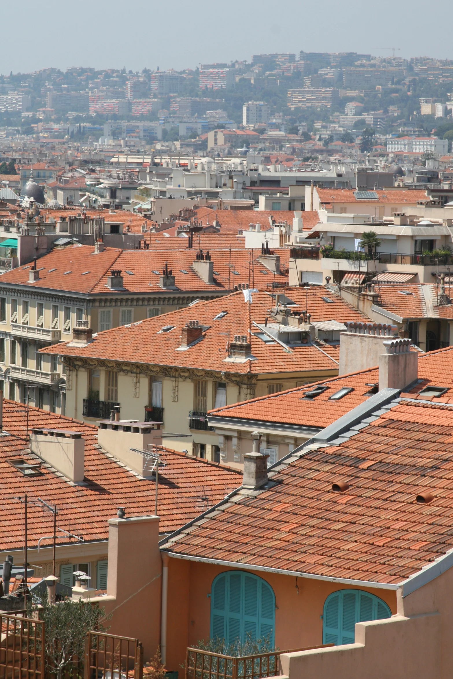 the roofs and windows of many large brown buildings