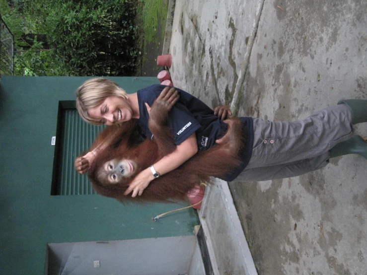 a person holding a monkey in their arms