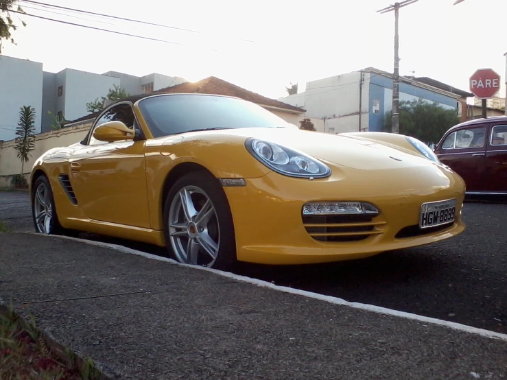 a yellow sports car parked in the road