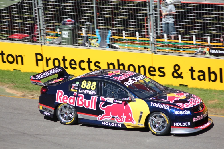 a person driving a red bull racing car down a track
