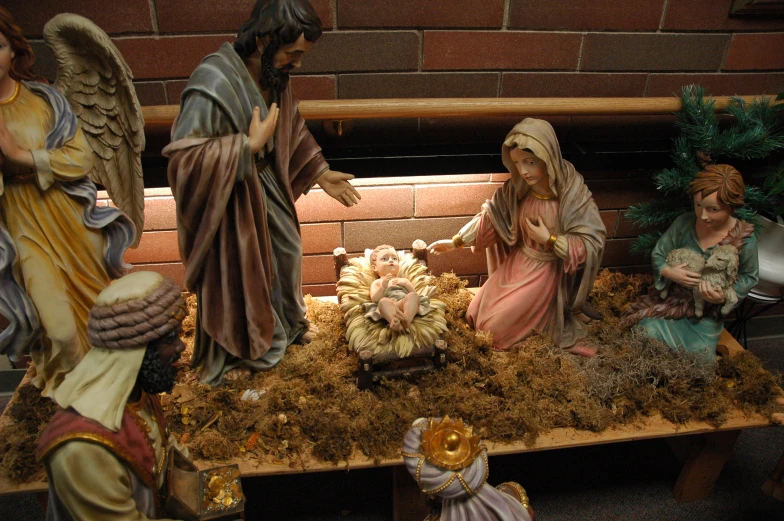 nativity scene featuring figurines made out of wood and wire