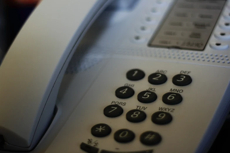 an old white telephone is set up with different ons