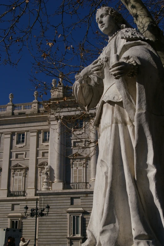 a statue of the emperor is in front of an old building