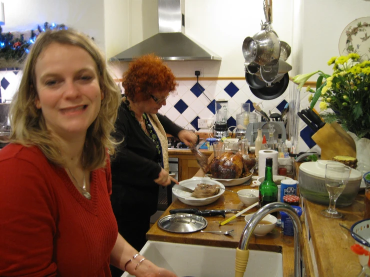 two women in the kitchen preparing food