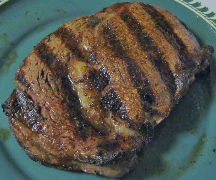 some very tasty looking looking meat on a green plate