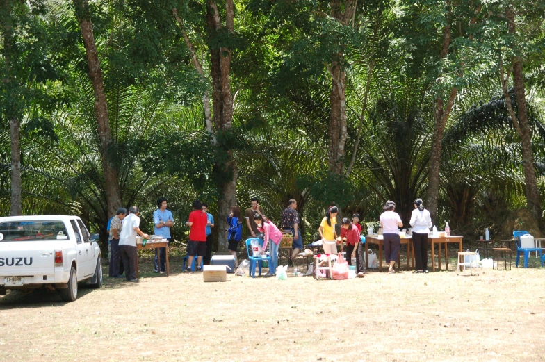 a group of people standing next to each other near a forest