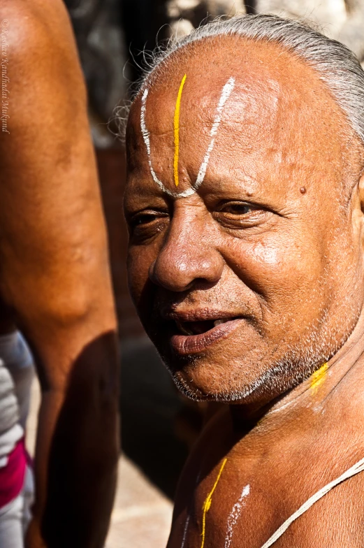 a white man with yellow lines painted on his face