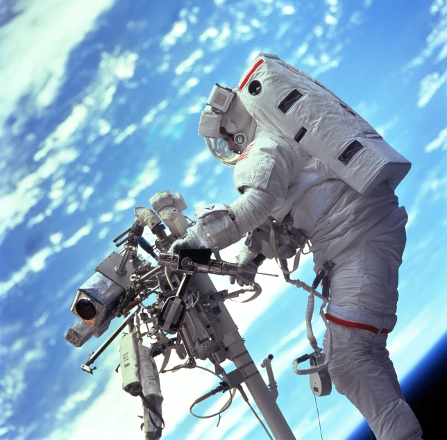 astronaut wearing all white and standing on the edge of space station