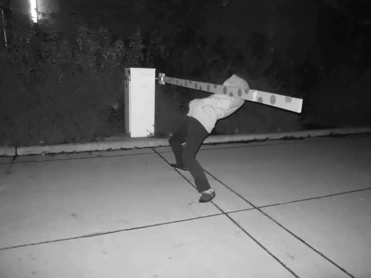 a person holds onto a large object in a black and white po