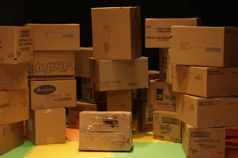 a pile of cardboard boxes sitting on a counter top