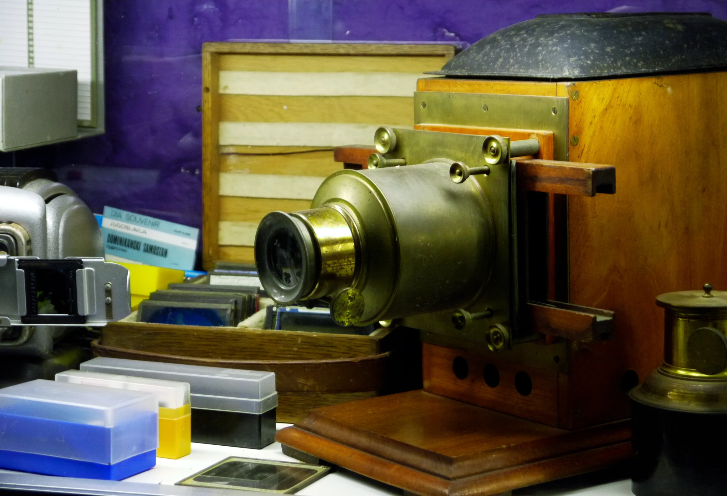 antique cameras sit on display in front of colorful wall