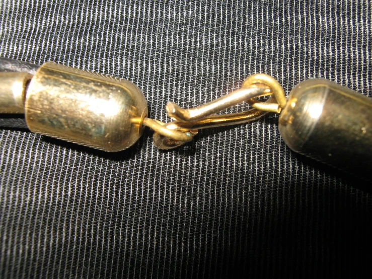 a pair of golden chains that link together on the back of a bag