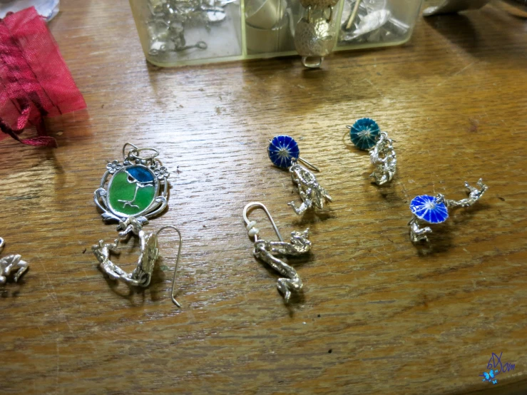 four charms on the table and some of them sitting on top
