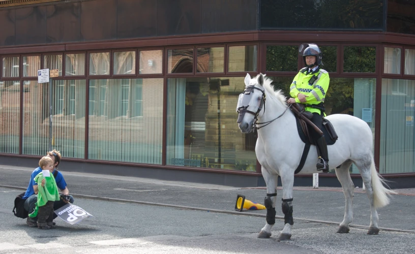 a policeman is riding a white horse outside