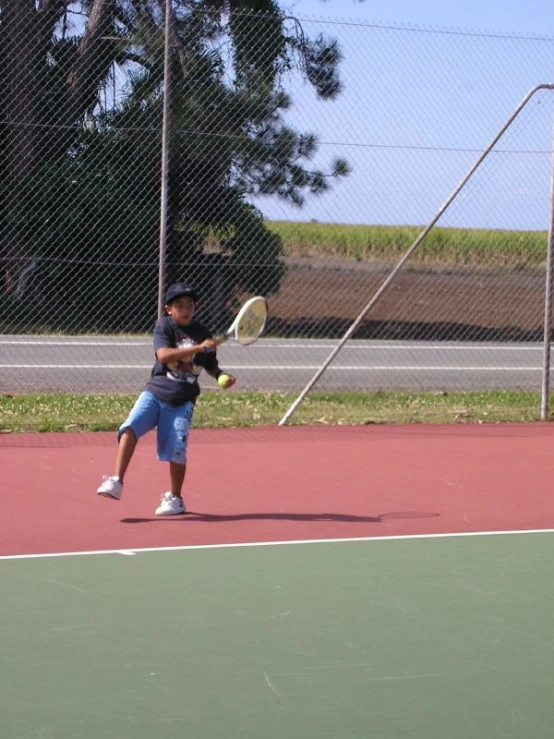 a girl holding a tennis racket waiting for the ball