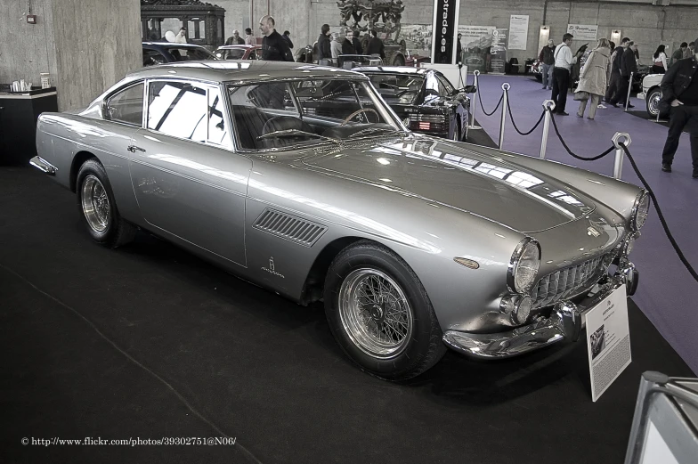 a silver car on display at an auto show