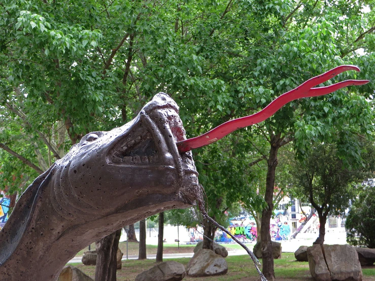 a sculpture of a head is shown with red scissors