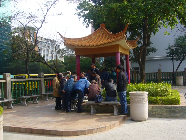 people gathering around a gazebo on a patio