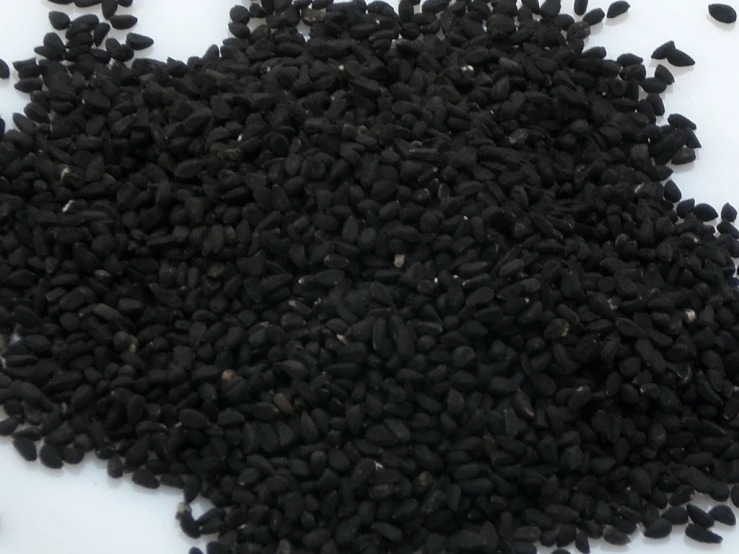 there is an open seed pattern made of black seeds