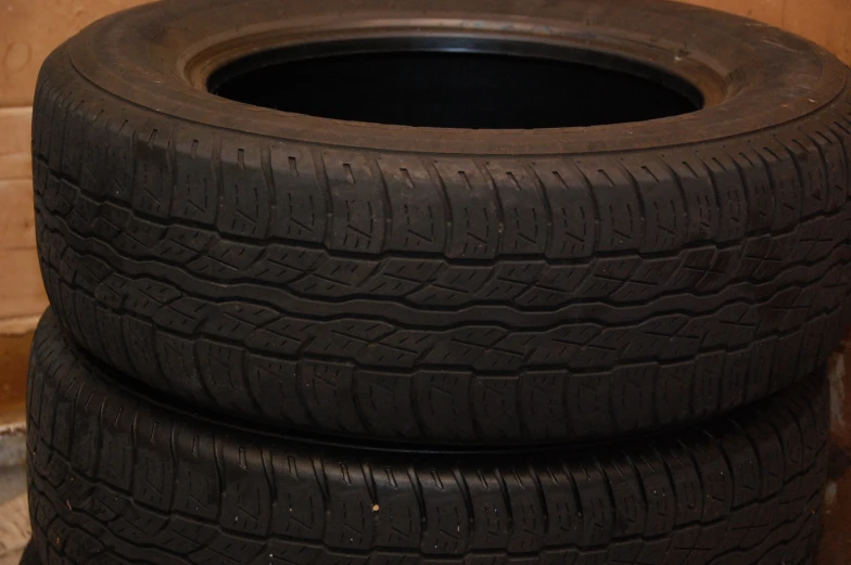 a stack of four used tires sitting on top of each other