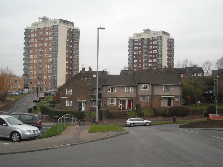 cars parked in the lot next to a row of buildings