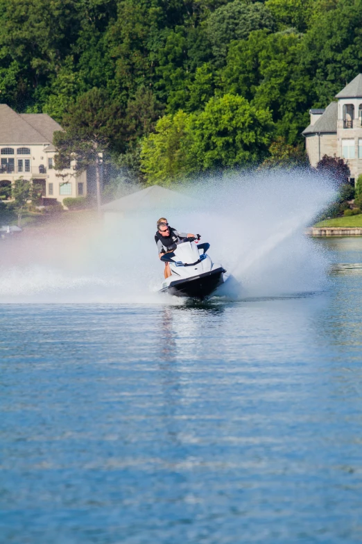 a person on a jet ski rides through water